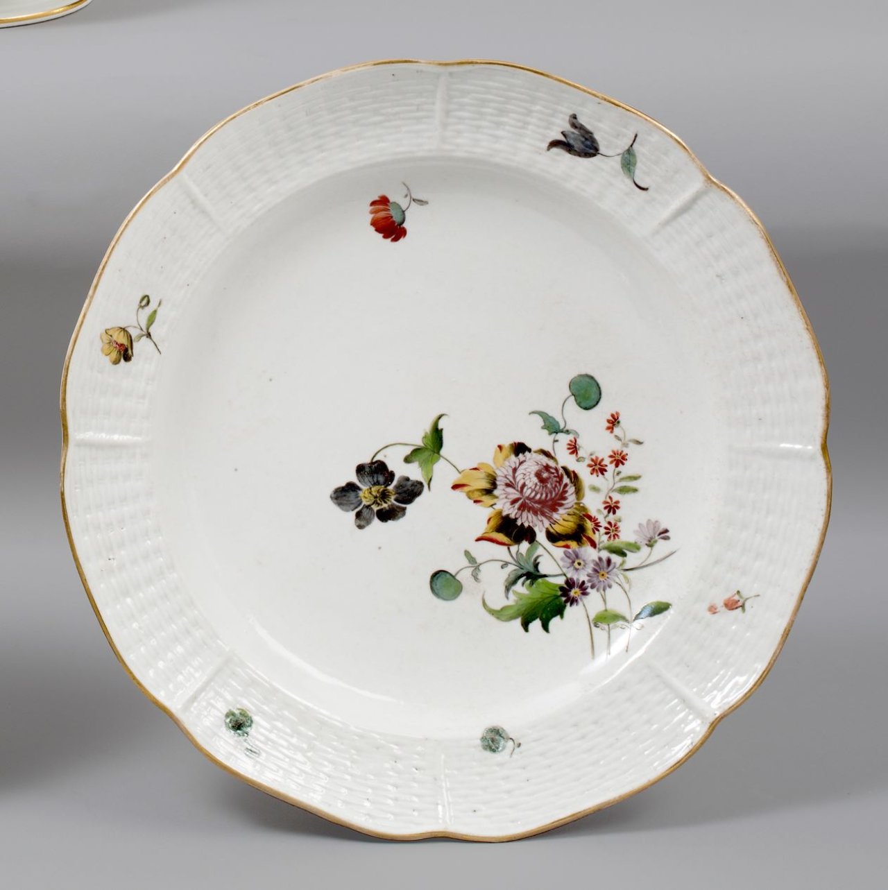 This picture shows the following artwork:  Porzellanmanufaktur Frankenthal. Plate, interlaced relief with bouquet, scattered flowers. 1756/57.