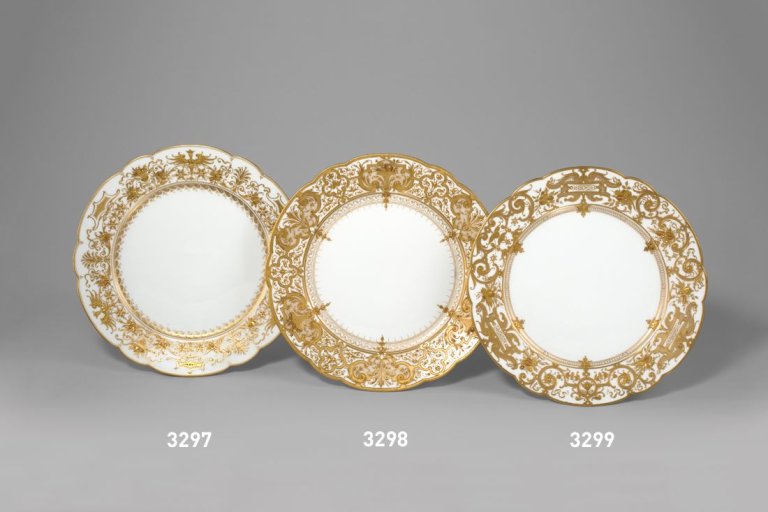 Auf diesem Bild ist das folgende Kunstwerk zu sehen:  KPM Königliche Porzellan-Manufaktur Berlin. Zierteller Augustaform mit Kartuschen und Obstkörben in Reliefgold. Um 1900.