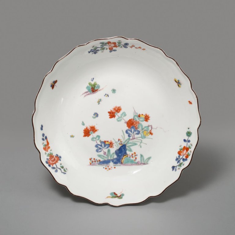 Auf diesem Bild ist das folgende Kunstwerk zu sehen:  Porzellanmanufaktur Meissen. Schüssel mit Kakiemon-Dekor (Blauer Berg mit Päonie) und braunem Rand. Um 1740.