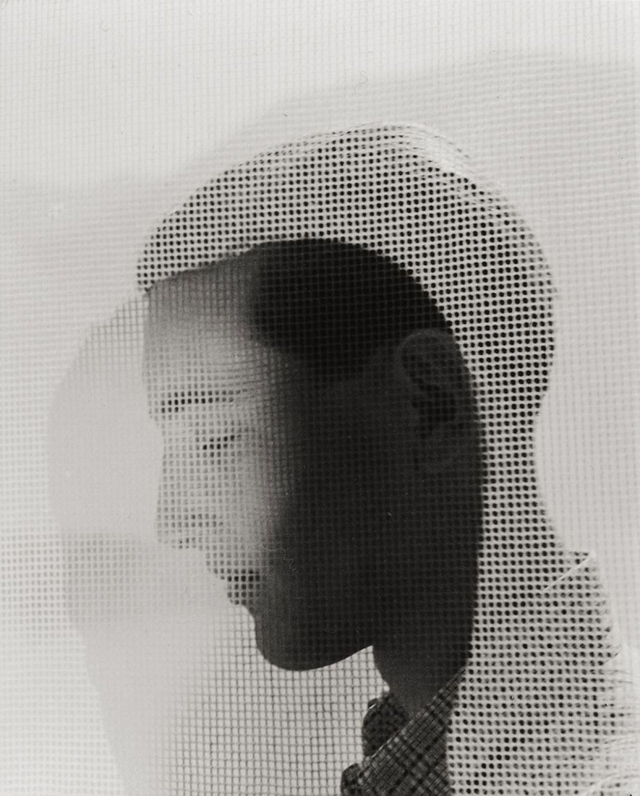 This picture shows the following artwork: Herbert List. Young man behind a curtain. Circa 1937.