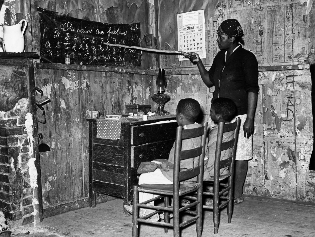 Catalog image of Negro mother teaching children numbers and alphabet in home of sharecropper, Tr…