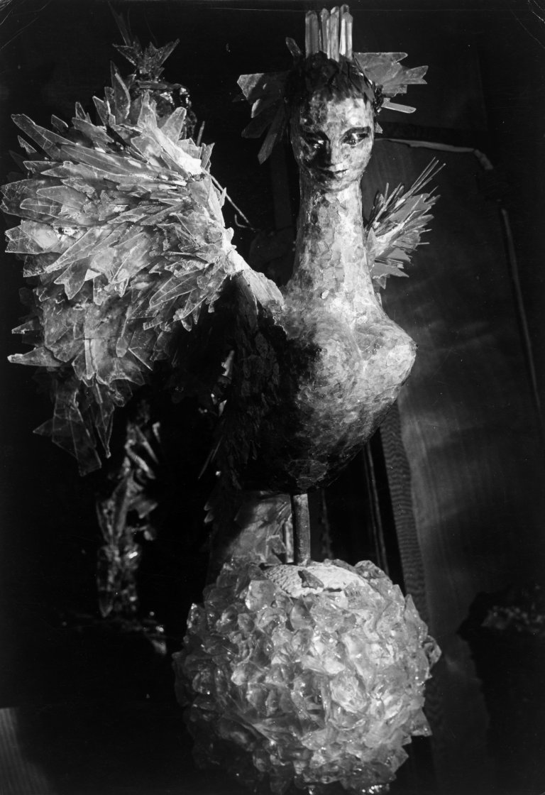 Auf diesem Bild ist das folgende Kunstwerk zu sehen:  Brassaï (d.i. Halász, Gyula). Sphinx-oiseau en crystal coloré et Nymphe pour une vitrine de Balenciaga, avenue George V., Paris. Composition de la décoratrice Janine Janet. 1957.