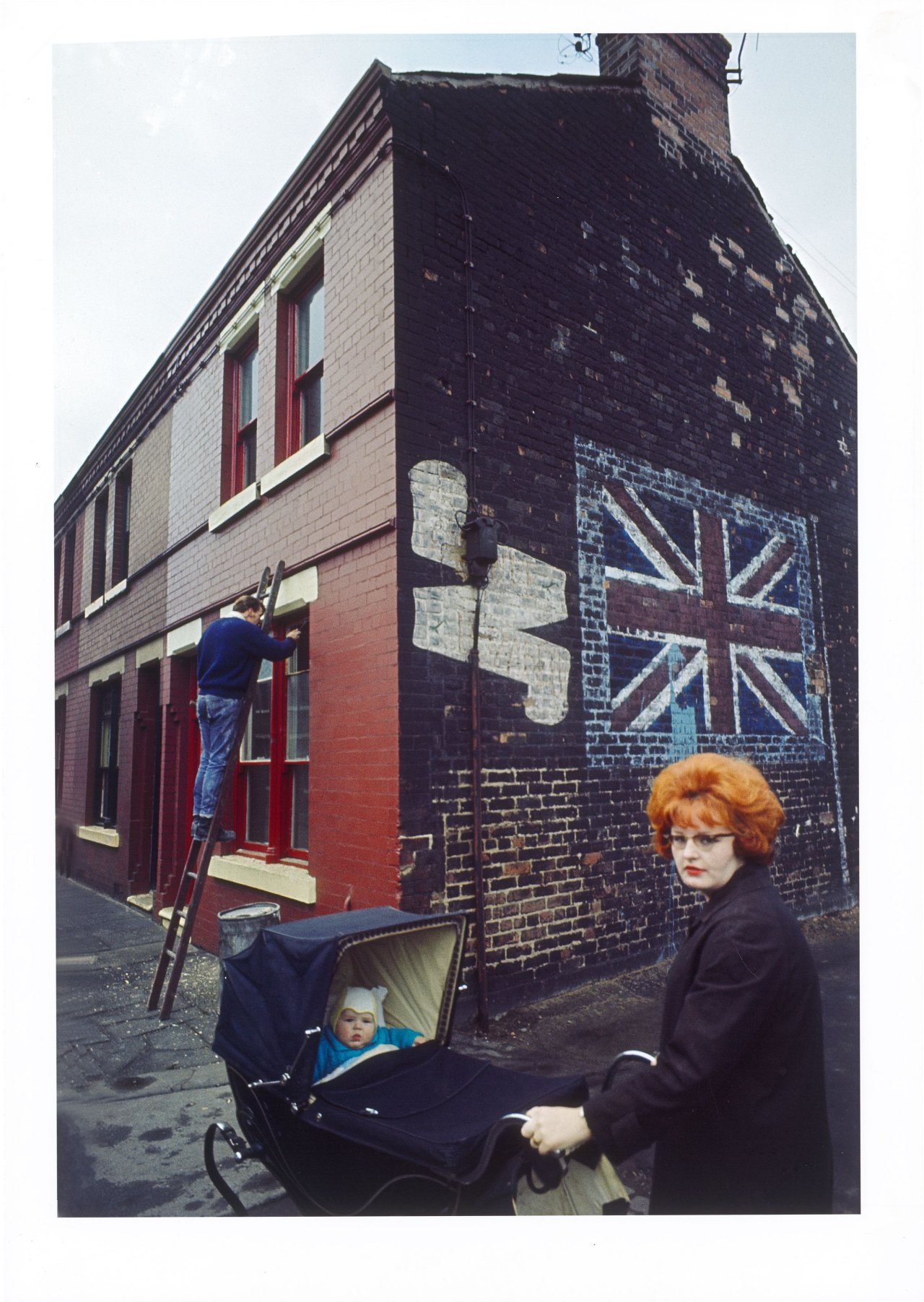 This picture shows the following artwork: John Bulmer. Redhead with Pram, Liverpool, from the series ”The North”. 1965.