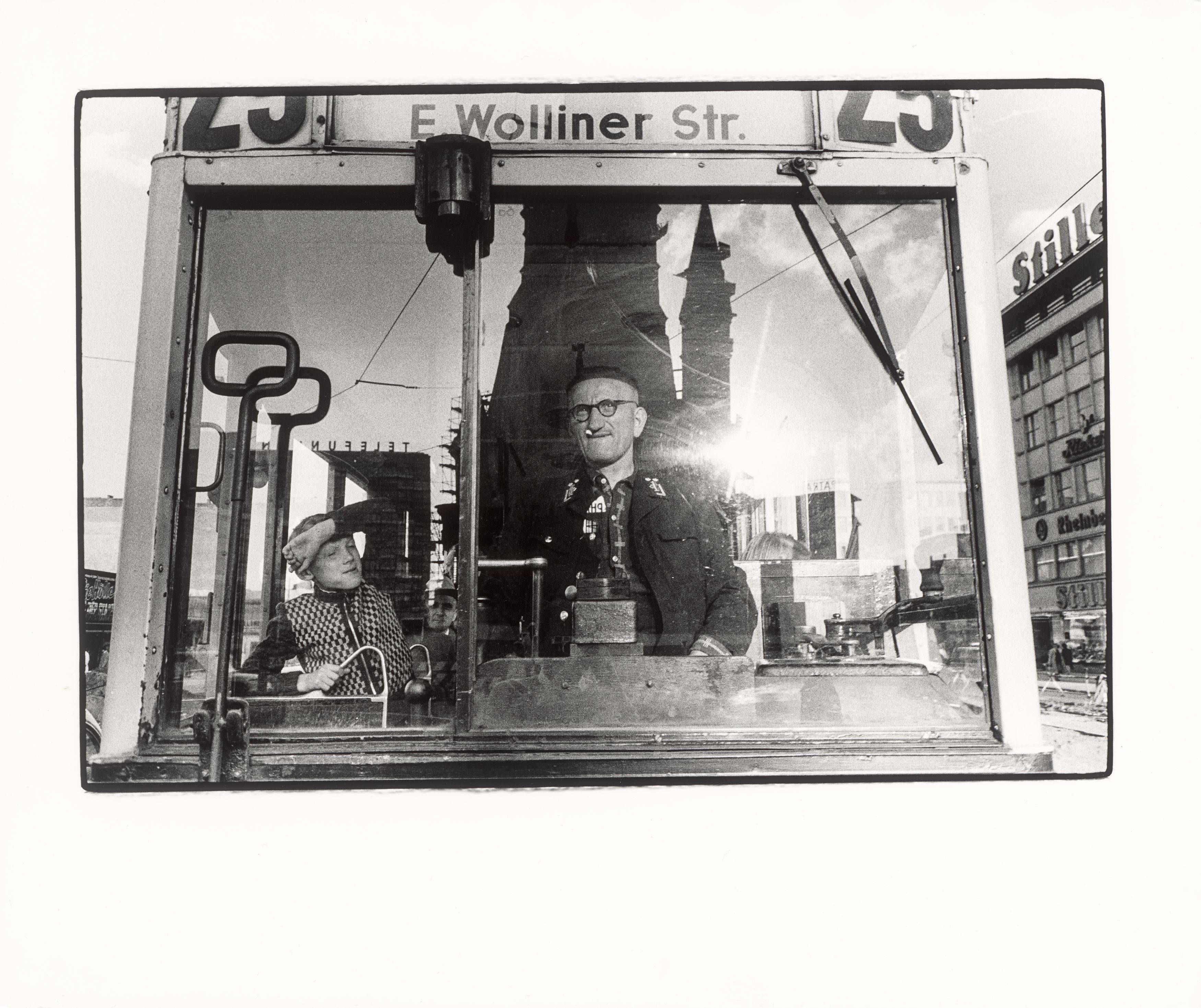 Auf diesem Bild ist das folgende Kunstwerk zu sehen: Will McBride. „Junge mit Straßenbahnfahrer in der Tauentzienstr. Berlin“. 1956.