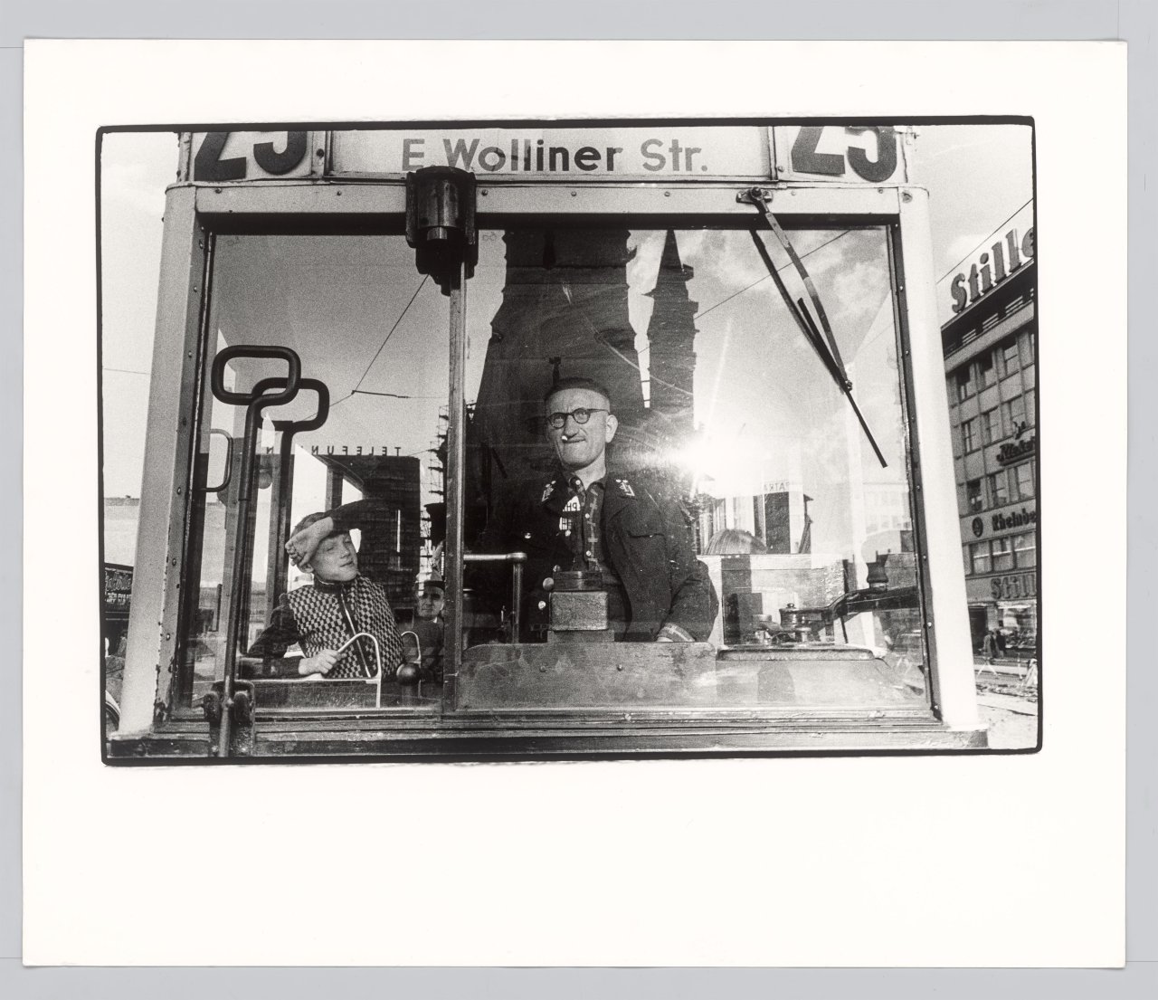 Auf diesem Bild ist das folgende Kunstwerk zu sehen: Will McBride. „Junge mit Straßenbahnfahrer in der Tauentzienstr. Berlin“. 1956.